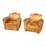 A PAIR FRENCH ART DECO CLUB ARMCHAIRS In distressed tan leather upholstery. (w 69cm x d 70cm x h