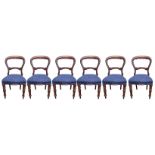 A SET OF SIX VICTORIAN STYLE MAHOGANY DINING CHAIRS Carved back rail overstuffed blue upholstery, on