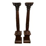 A PAIR OF 19TH CENTURY AND LATER OAK TORCHERES With finely carved acanthus scroll Corinthian