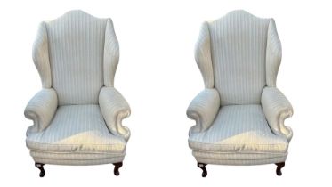 A PAIR OF EARLY 20TH CENTURY GEORGIAN STYLE WING ARMCHAIRS In oatmeal fabric upholstery with loose