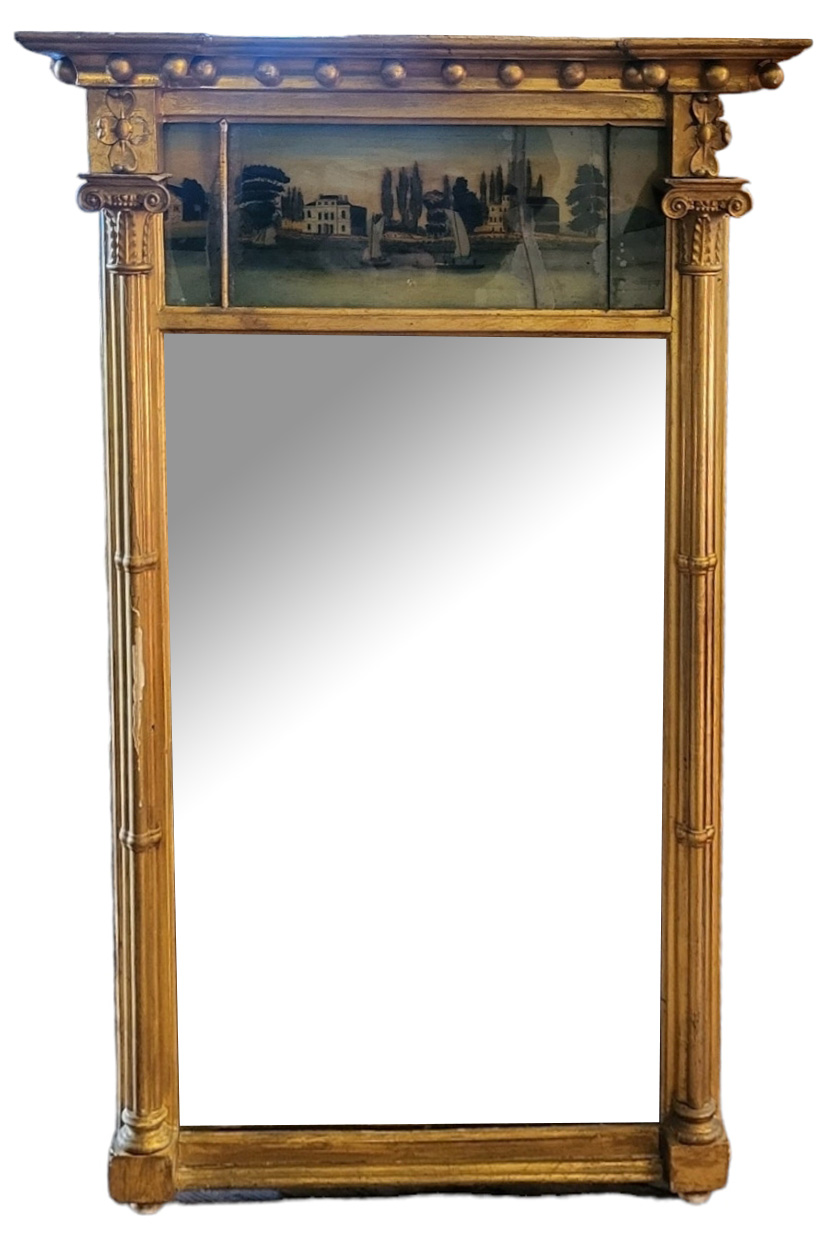 A 19TH CENTURY GILT FRAMED TRUMEAU MIRROR The reverse glass painted riverside landscape flanked by