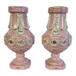 A PAIR OF CONTINENTAL BALUSTER PORCELAIN VASES With classical applied swags, floral decoration on