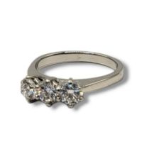 A PLATINUM AND DIAMOND THREE STONE RING The round cut diamonds in plain platinum mount,together with