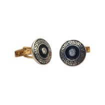 A PAIR OF 14CT GOLD, DIAMOND AND ENAMEL CUFFLINKS The single round cut diamond in blue enamel with