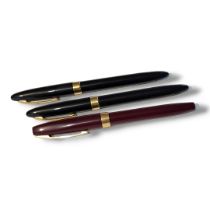 SHEAFFER, THREE VINTAGE FOUNTAIN PENS Having two black case and one burgundy,each having 14ct