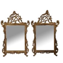 A PAIR OF 18TH CENTURY STYLE CHIPPENDALE INSPIRED GILTWOOD FRAMED MIRRORS With elaborate carved