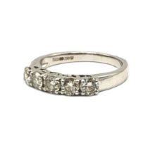 AN 18CT WHITE GOLD FIVE STONE DIAMOND RING The single row of round cut diamonds in