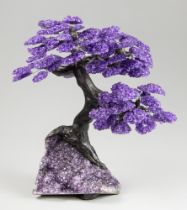 A LARGE AMETHYST GEMSTONE TREE ON AMETHYST GEODE (h 41cm x w 40cm x d 32cm)