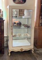 A LARGE LOUIS XV STYLE RETAIL OR CURIO DISPLAY CABINET. Painted white with gilt detail, three glazed