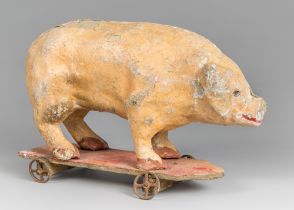 A 19TH CENTURY PAPIER MÂCHÉ PIG TOY. (h 27cm x w 41cm x d 14cm)