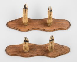 A PAIR OF DEER HOOF GUN OR WHIP RACKS.