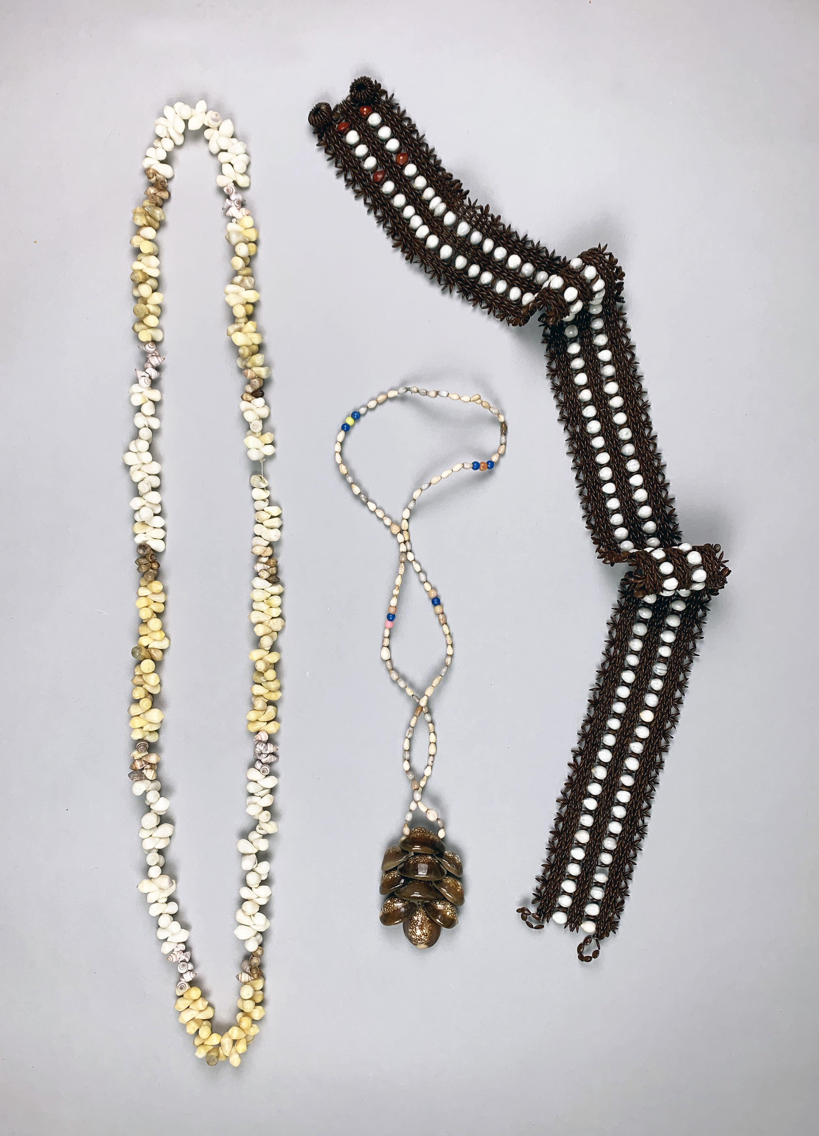 TWO SOLOMON ISLANDS SEASHELL NECKLACES AND A SEASHELL BELT. Provenance: Private English