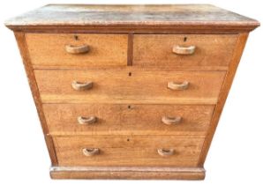 MANNER OF HEALS, AN EARLY 20TH CENTURY OAK CHEST Of two short over three long graduated drawers,