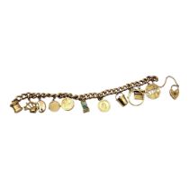 A VINTAGE 9CT GOLD CURB LINK CHARM BRACELET AND CHARMS Having heart shaped padlock clasp, charms