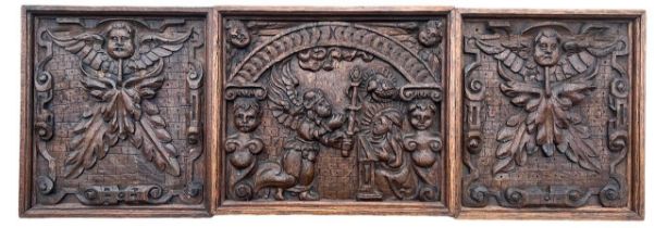 THREE MID 16TH CENTURY ENGLISH CARVED OAK PANELS Decorated with The Annunciation flanked by two