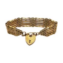 AN EDWARDIAN 9CT GOLD GATE LINK BRACELET Having chased and engraved heart padlock clasp, links