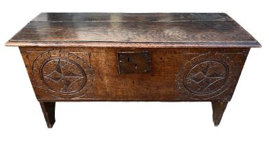 AN 18TH CENTURY OAK COFFER With hinge lid the front panel carved with circular medallions. (h 51cm x