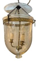 A REGENCY DESIGN GILT METAL AND ETCHED GLASS HANGING STORM LANTERN Decorated with scrolling