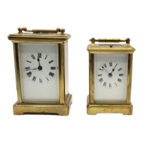 TWO EARLY 20TH CENTURY GILT METAL CARRIAGE CLOCKS Both having white enamelled dial with Roman