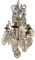 A DECORATIVE FRENCH LOUIS XV DESIGN GILT ORMOLU AND CRYSTAL GLASS FIVE BRANCH CHANDELIER. (drop 65cm