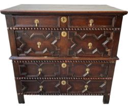 A 17TH CENTURY CHARLES II OAK TWO SECTION CHEST Of four long drawers with moulded geometrical,