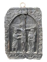 A 18TH CENTURY CARVED BLACK OAK CARVED PANEL DEPICTING THE CRUCIFIXION IN DEEP RELIEF. (41.5cm x