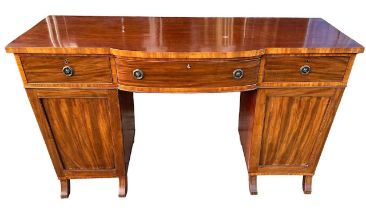 A REGENCY MAHOGANY BREAKFRONT PEDESTAL SIDEBOARD With three drawers above cupboard doors, raised