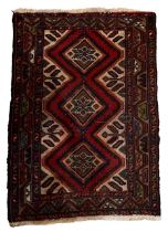 A SHIRAZ RED GROUND PRAYER RUG Decorated with stylised geometrical patterns. (80cm x 114cm)
