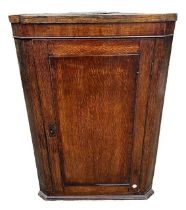 AN 18TH CENTURY OAK WALL HANGING CORNER CABINET The single door opening to reveal shelf interior