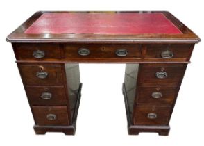 A LATE 19TH CENTURY MAHOGANY PEDESTAL DESK OF SMALL PROPORTIONS Having an arrangement of nine