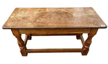 ROBERT THOMPSON (MOUSEMAN), AN OAK COFFEE TABLE The rectangular adzed top support on faceted