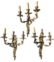 A SET OF THREE FRENCH GILT BRONZE LOUIS XVI ROCOCO DESIGN THREE BRANCH WALL SCONCES Decorated with