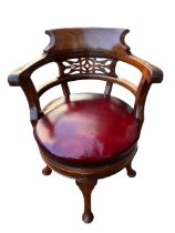 A LATE 19TH CENTURY WALNUT REVOLVING CAPTAINS ARMCHAIR with pierced back above leather seat raised