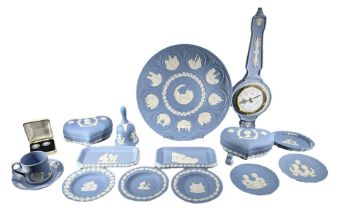 WEDGWOOD, A COLLECTION OF BLUE JASPERWARE ITEMS Comprising a plate, dishes, lidded boxes, barometer,