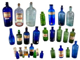 A LARGE COLLECTION OF LATE 19TH/EARLY 20TH CENTURY APOTHECARY GLASS BOTTLES To include examples from