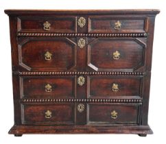 A 17TH CENTURY CHARLES II OAK TWO SECTION CHEST Of four long drawers with moulded drawer fronts, and