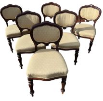 A SET OF SIX 19TH CENTURY VICTORIAN MAHOGANY AND UPHOLSTERED DINING CHAIRS The carved shape backs