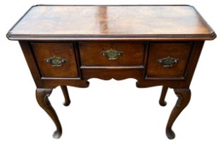 A GEORGE III DESIGN OAK LOWBOY The shaped top above three drawers, raised on four cabriole legs. (