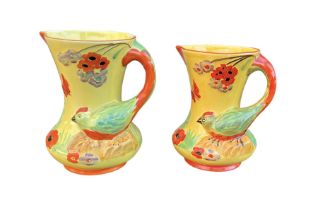 WADEHEATH, ENGLAND POTTERY, TWO ART DECO BIRD JUGS, CIRCA 1930 All having yellow ground, stylised