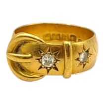 A 1910’S 18CT YELLOW GOLD AND DIAMOND STYLISED BUCKLE RING Two gypsy set brilliant round cut