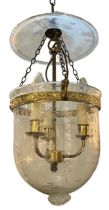 A REGENCY DESIGN GILT METAL AND ETCHED GLASS HANGING STORM LANTERN Decorated with scrolling