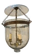 A LARGE REGENCY DESIGN GILT METAL AND CUT GLASS HANGING STORM LANTERN Decorated with scrolling