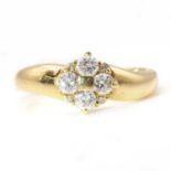 An 18ct gold four stone diamond quatrefoil cluster ring,