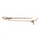 An Art Nouveau gold pearl stick pin,