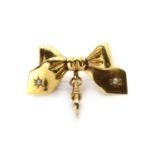 A gold split pearl bow brooch,