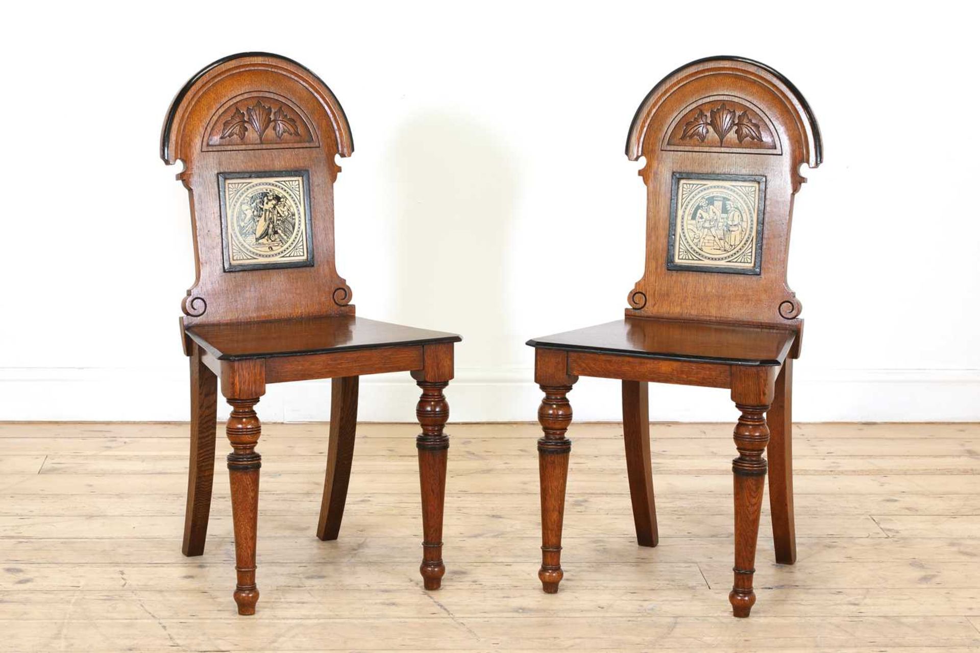 A pair of Aesthetic Movement oak and ebonised hall chairs,