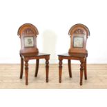 A pair of Aesthetic Movement oak and ebonised hall chairs,