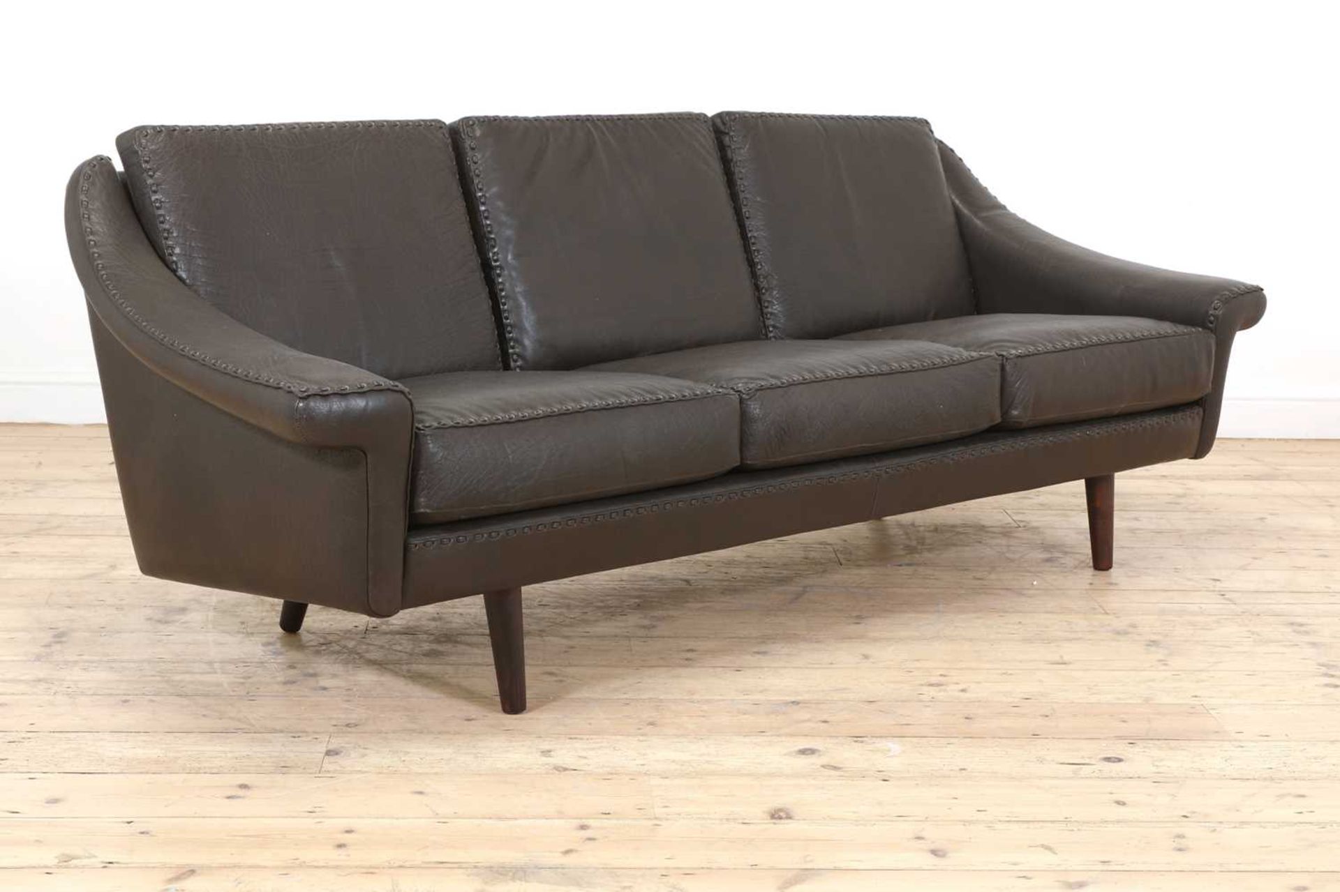 A Danish brown leather three-seater settee,