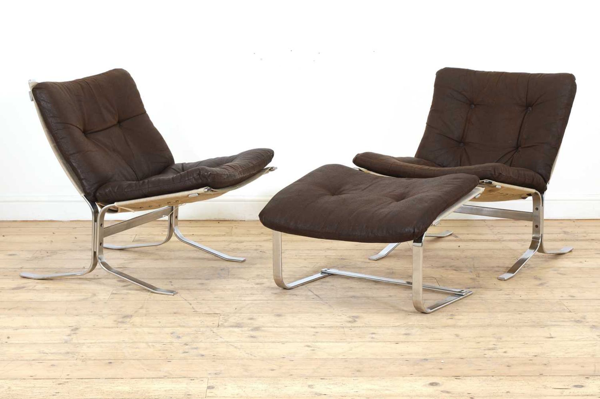 A pair of Westnofa chrome and leather loungers,