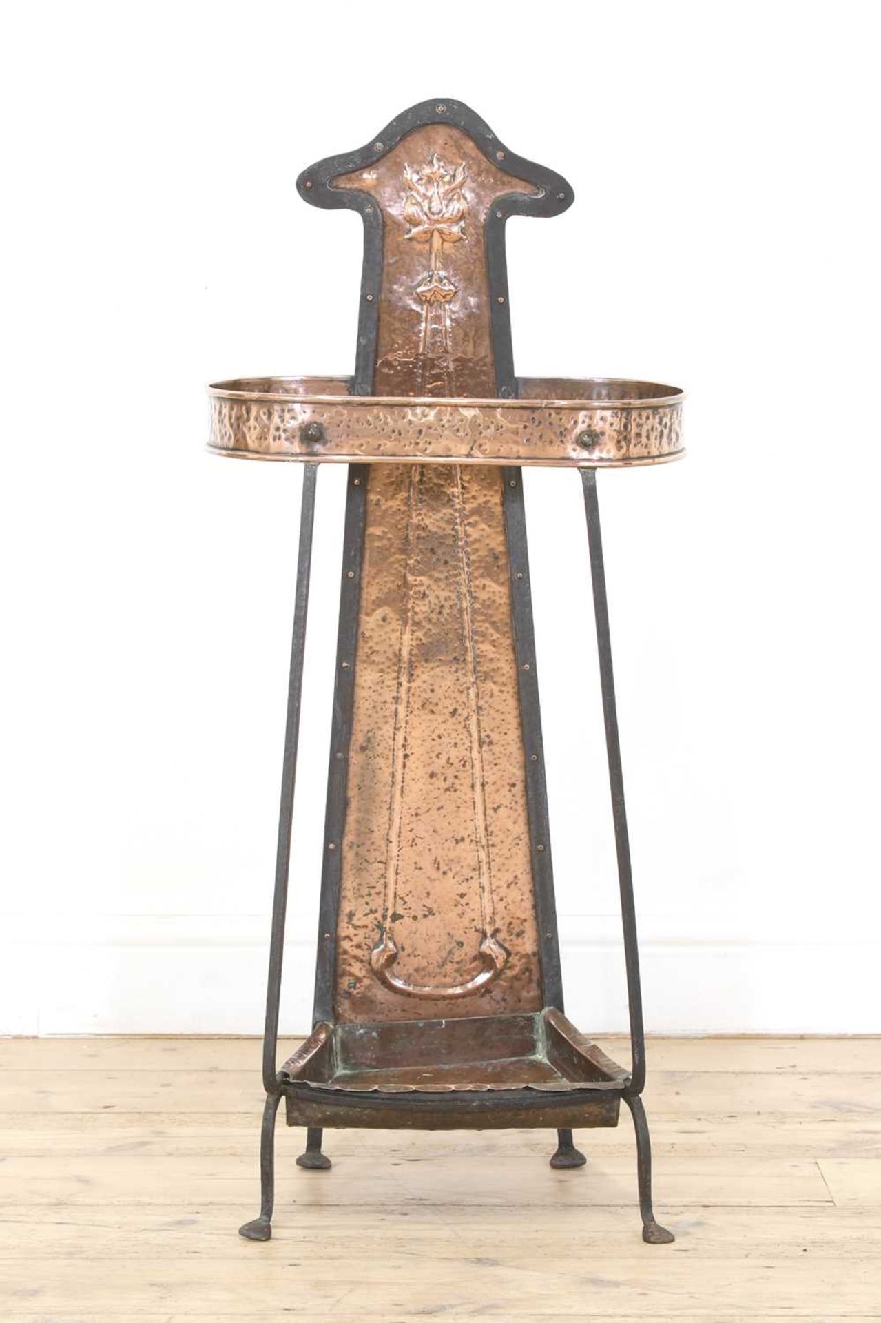 An Arts and Crafts copper and wrought iron umbrella stand,